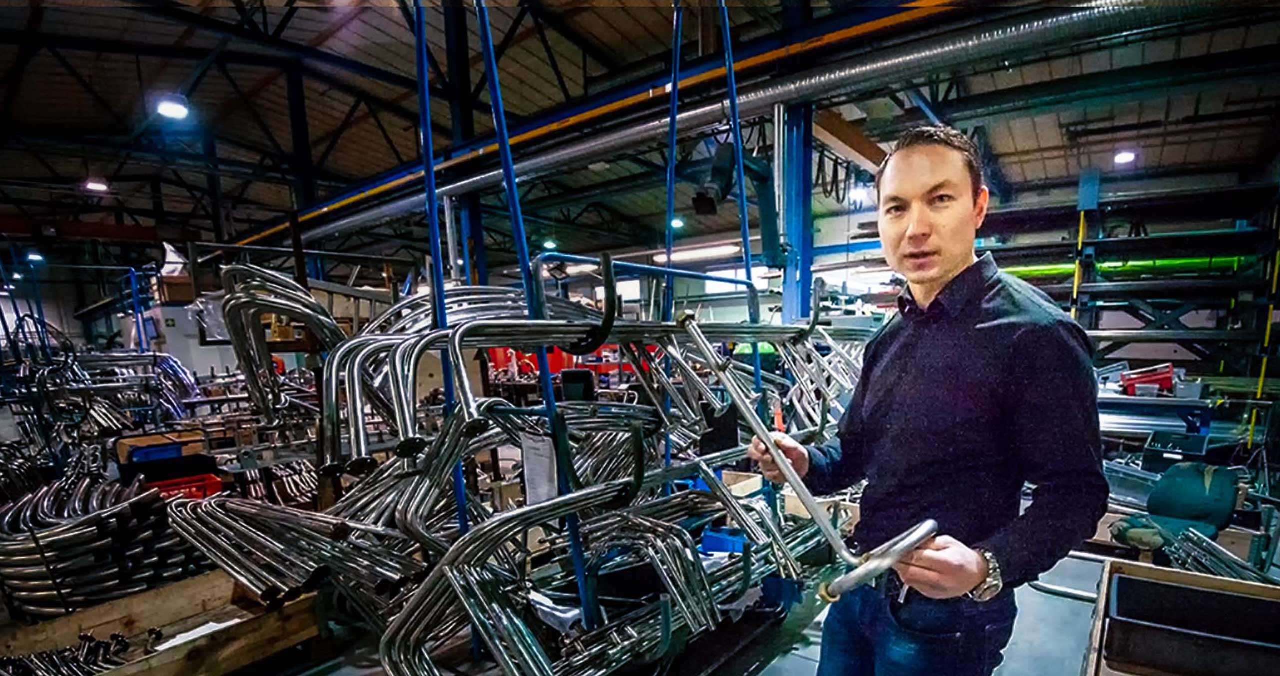 Joros Oy's long-term pilot, Toni Pesonen, presents bent pipes at the company's premises.